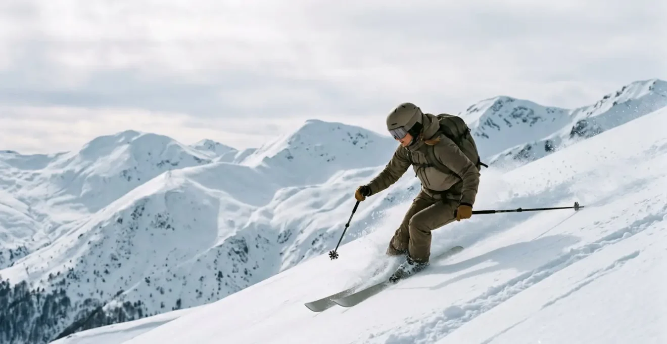 Expert skier navigating steep mountain terrain on a challenging black run in North Macedonia with dramatic alpine peaks in the background