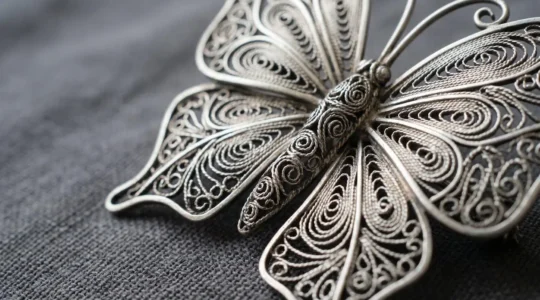 Delicate Macedonian filigree silver butterfly brooch showcasing intricate handcrafted wire patterns