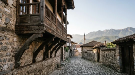 Detailed view of traditional Ottoman wooden balcony architecture with intricate carved brackets against stone walls in North Macedonia historic quarter