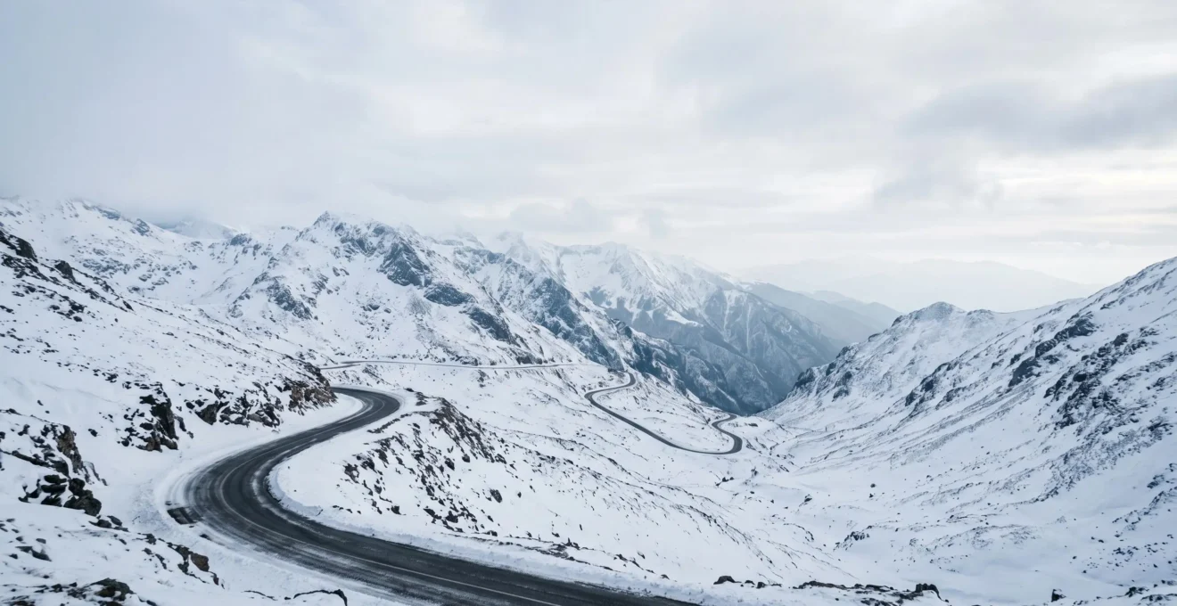 Mountain road winding through snowy Macedonian peaks with winter driving conditions
